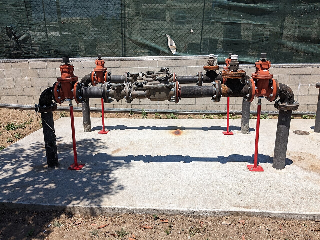 Backflow prevention assembly installed on a concrete pad